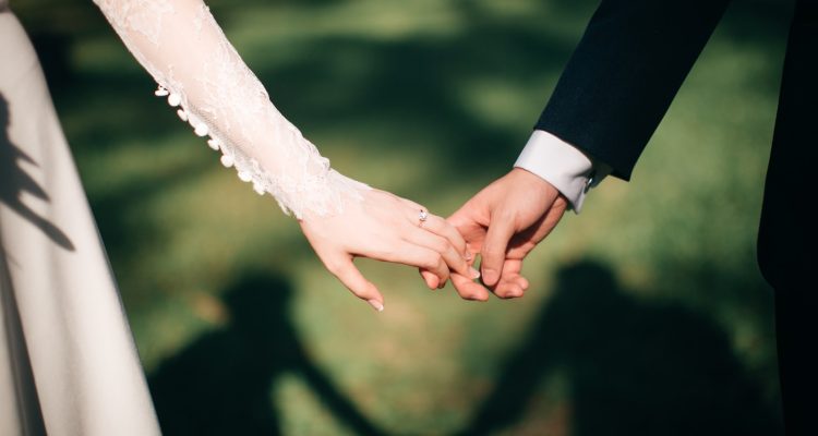 man and woman holding hands focus photo